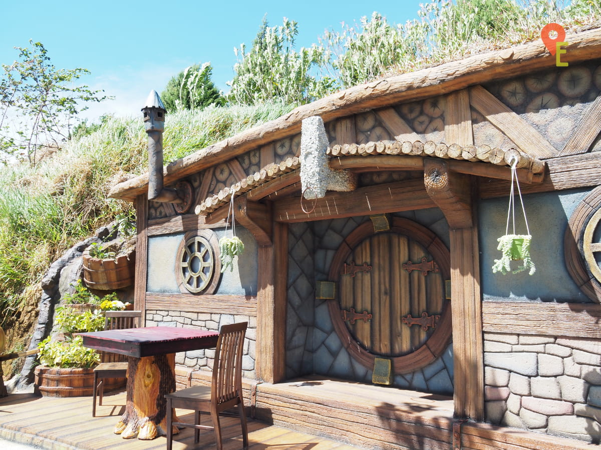 This Hobbit House At Hobbitoon Village Has A Table And Chairs In Front